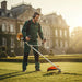 Professional landscaper maintaining European manor estate grounds with CLA220 52cc 2-stroke heavy-duty gas grass trimmer-minisawpro