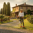 Woman trimming cobblestone path grass in Tuscan villa garden with CLA200 35cc 4-stroke gas grass trimmer-minisawpro