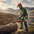 British forest ranger cutting timber in Scottish Highlands woodland management with 2J00 25.4cc gas chainsaw-minisawpro