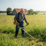 Elderly man clearing thick weeds on German countryside farm with MIP2J11 52cc 2-stroke gas grass trimmer-minisawpro