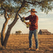 Elderly American farmer pruning crop field edge branches with M11 mini lithium cordless chainsaw compact one-hand pruning saw-minisawpro
