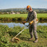 Man clearing overgrown weeds along riverbank with MIP139 35.8cc 4-stroke gas grass trimmer – outdoor lawn tool-minisawpro