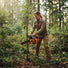 American woman clearing woodland brush in Pacific Northwest forest with 2J000 25.4cc gas chainsaw-minisawpro