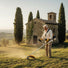 Elderly man trimming grass around stone chapel in Italian countryside with MIP2J11 52cc 2-stroke gas trimmer-minisawpro