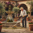 Elderly man clearing weeds around stone fountain in Mediterranean villa courtyard with J66 41.6cc gas grass trimmer-minisawpro