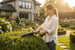 Woman using MiniSawPro M10 cordless chainsaw to trim garden hedges – lightweight pruning saw for home use