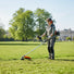Woman maintaining large estate lawn with S680 gas grass trimmer – powerful 2-stroke portable mower-minisawpro
